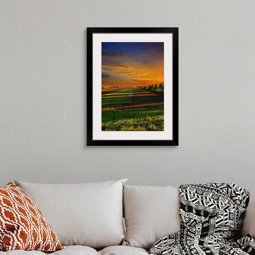 A bohemian room featuring Dramatic photograph of a countryside scene.