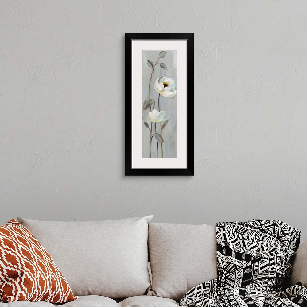 A bohemian room featuring Tall cool toned painting of white flowers with long, thin stems on a grey background.