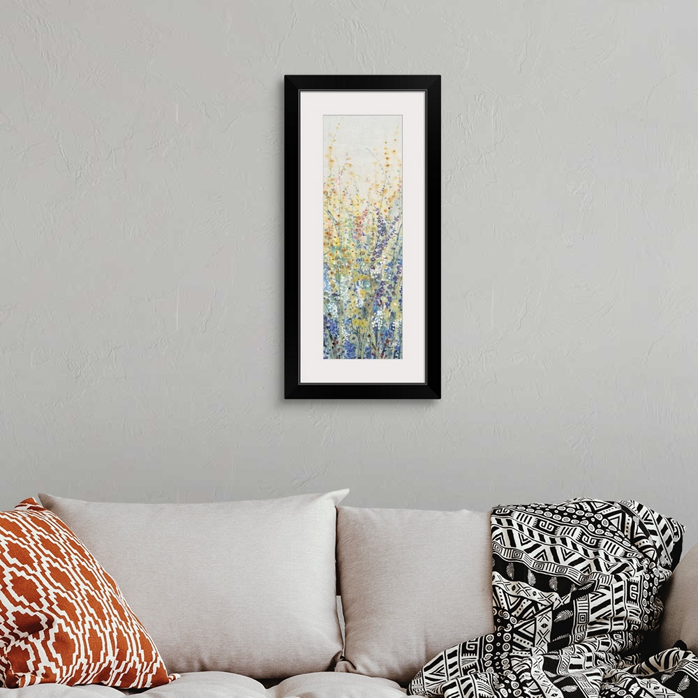 A bohemian room featuring Vertical panel of blooming yellow and blue wildflowers in a field.