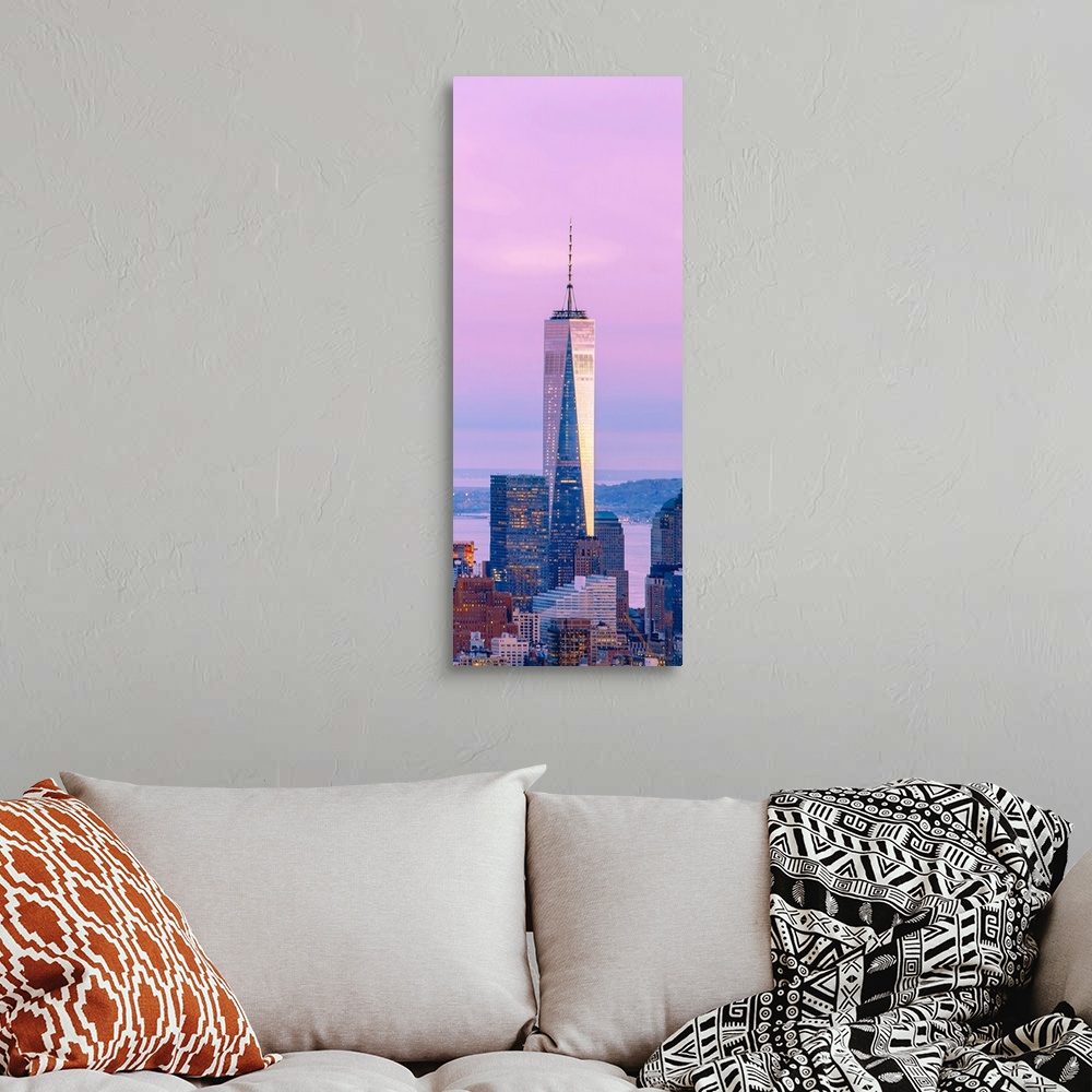 A bohemian room featuring Illuminated One World Trade Center amidst buildings against sky in city at dusk, Manhattan, New Y...