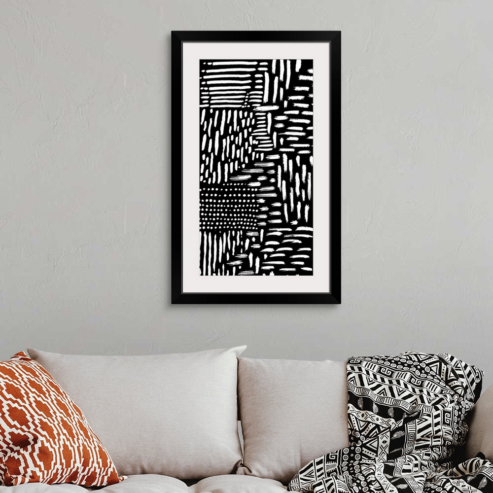 A bohemian room featuring Abstract painting of several white strokes on black.
