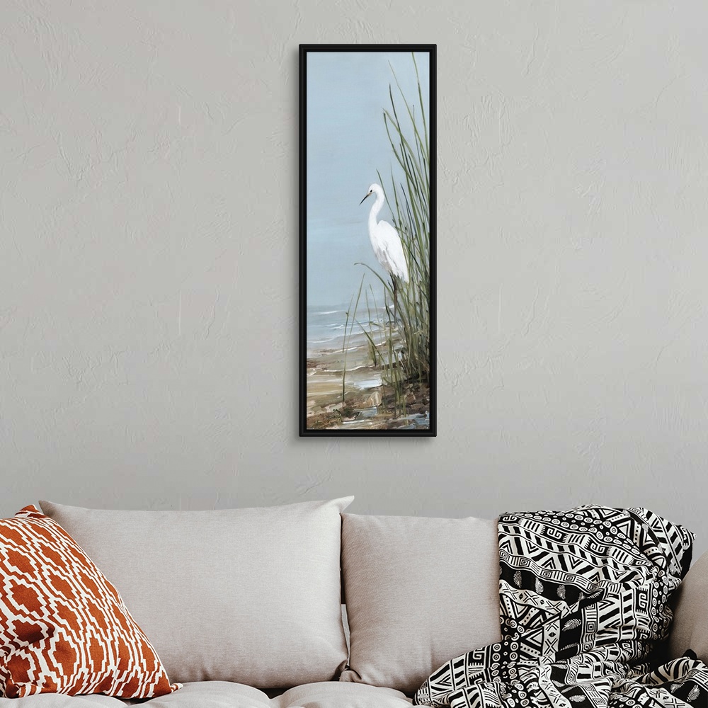 A bohemian room featuring Tall panel painting of an egret walking on the shore with tall beach grass.