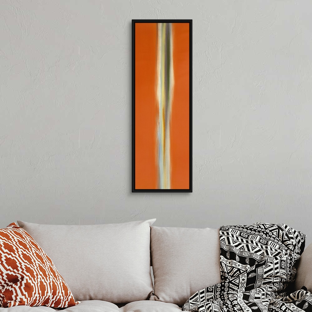 A bohemian room featuring A tall vertical piece of abstract artwork that has orange on both sides with a neutral colored li...