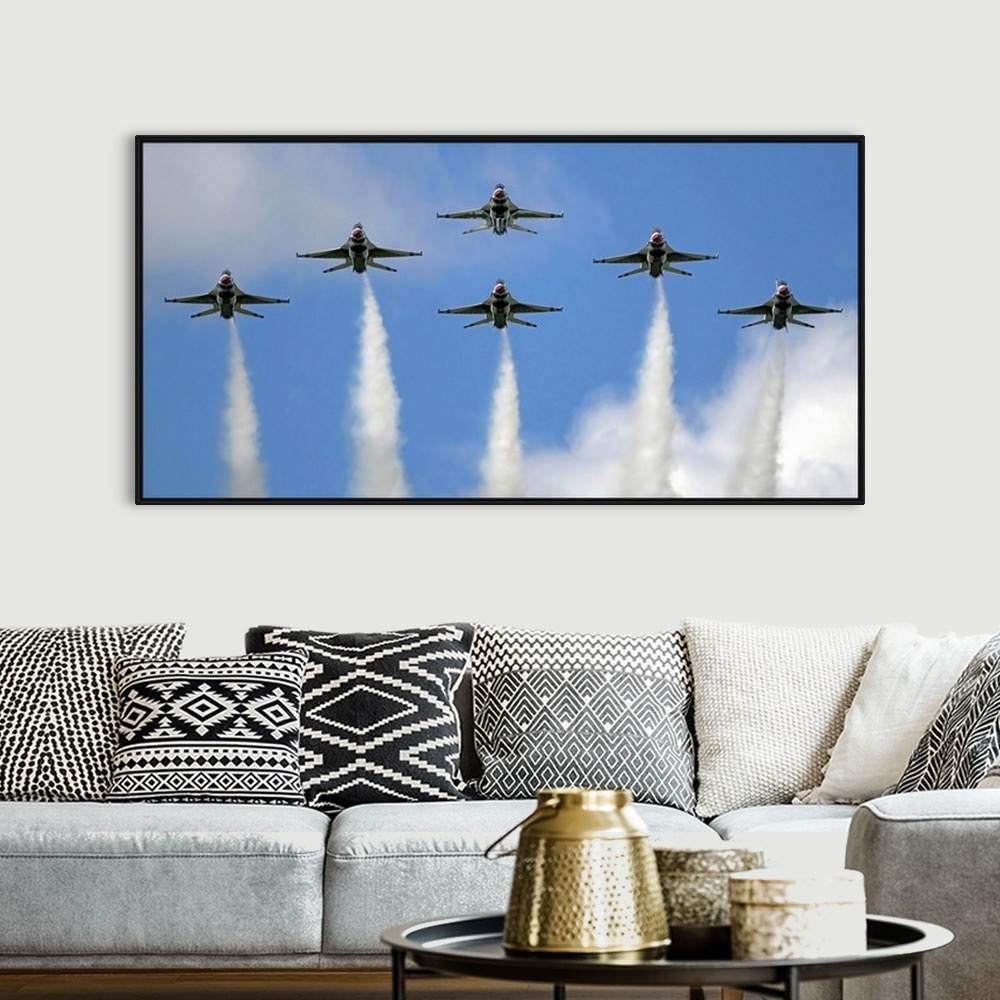 A bohemian room featuring Photograph of six military planes in formation with smoke trails.