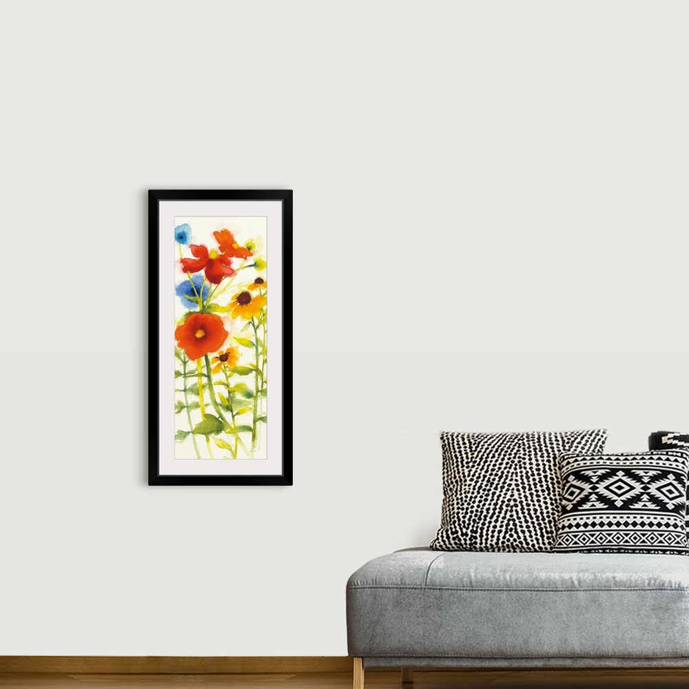 A bohemian room featuring Tall watercolor painting of red, yellow, and blue flowers on a white background.