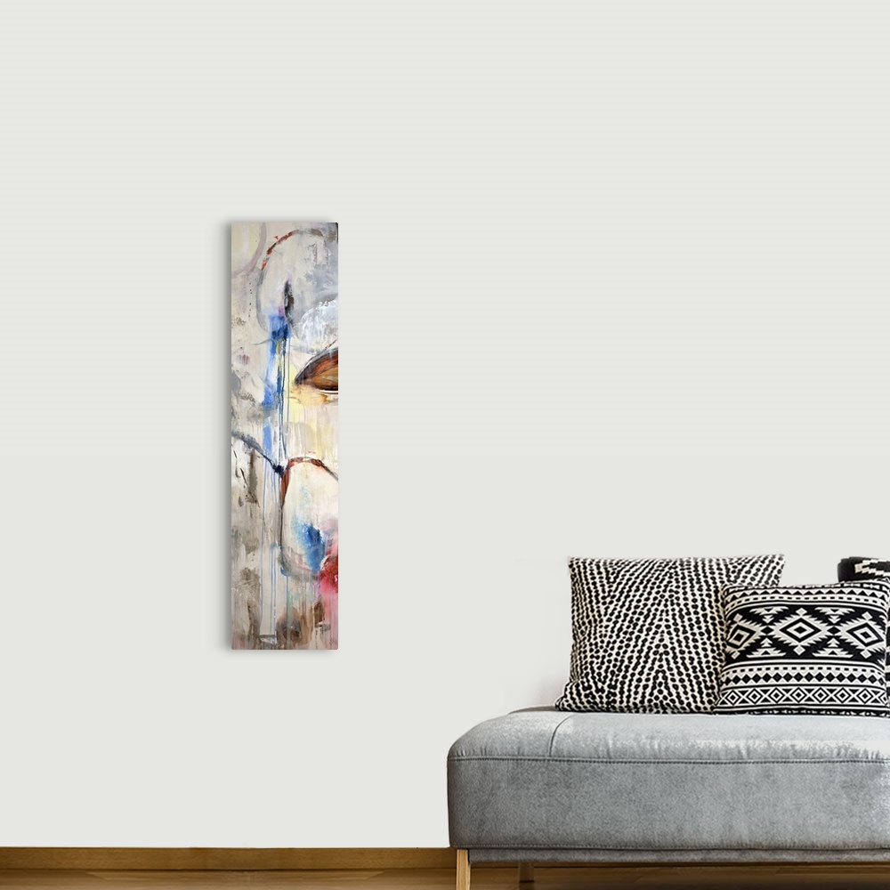 A bohemian room featuring A tall panoramic piece of abstract artwork that uses a neutral background with pops of color that...