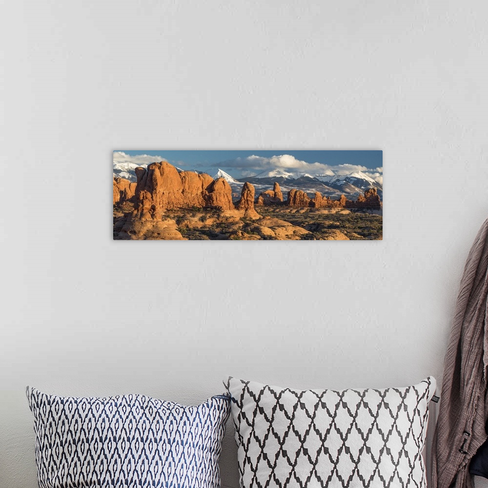 A bohemian room featuring North America, USA, Utah.  Red rock formations of the Windows Section with clouds and snow on the...