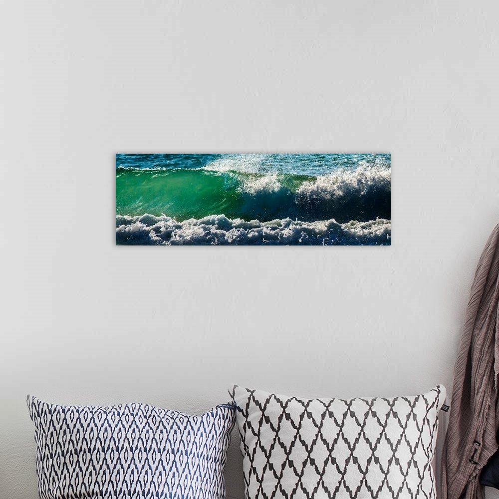 A bohemian room featuring Panoramic photograph of an ocean wave.