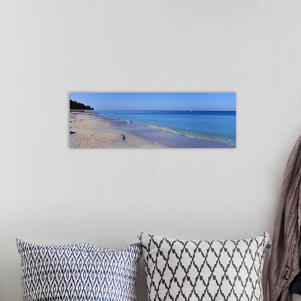 A bohemian room featuring Horizontal canvas photo of calm waves rolling ashore from the Gulf of Mexico.