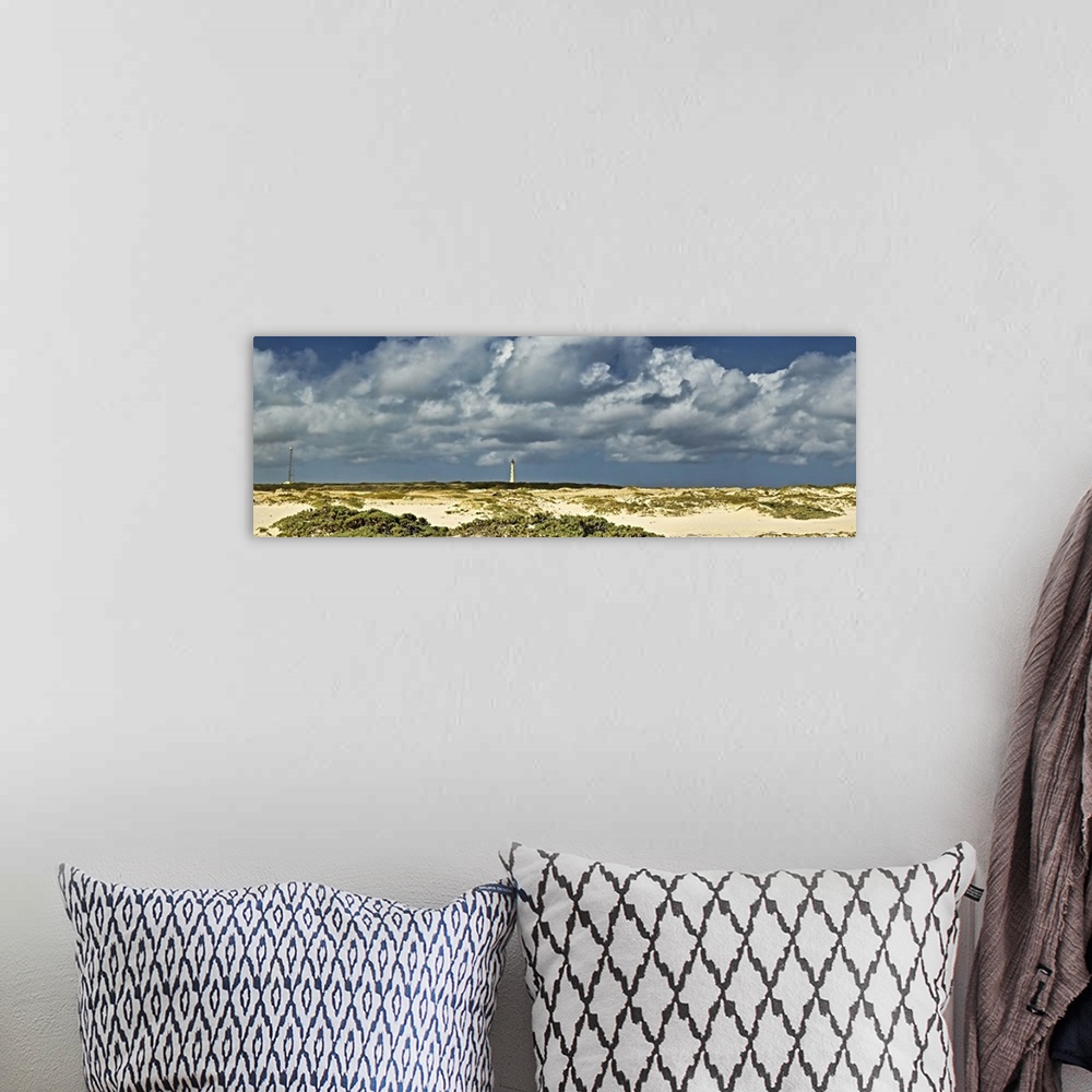 A bohemian room featuring Clouds over the beach with California Lighthouse in the background, Aruba