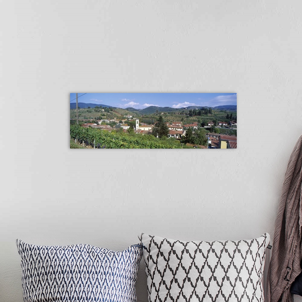 A bohemian room featuring Panoramic canvas photo of an Italian town on rolling hills.