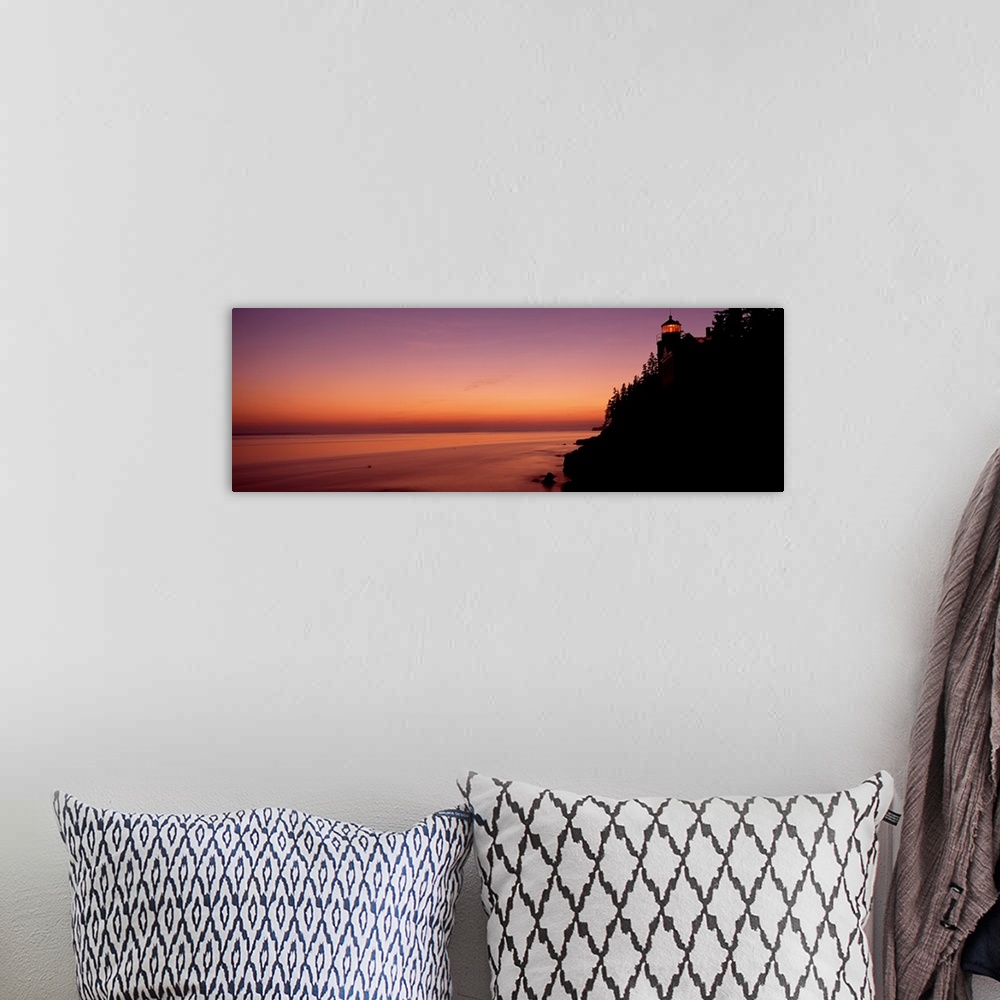 A bohemian room featuring Panoramic photograph taken during a sunset with a lighthouse shown on the right side of the pictu...