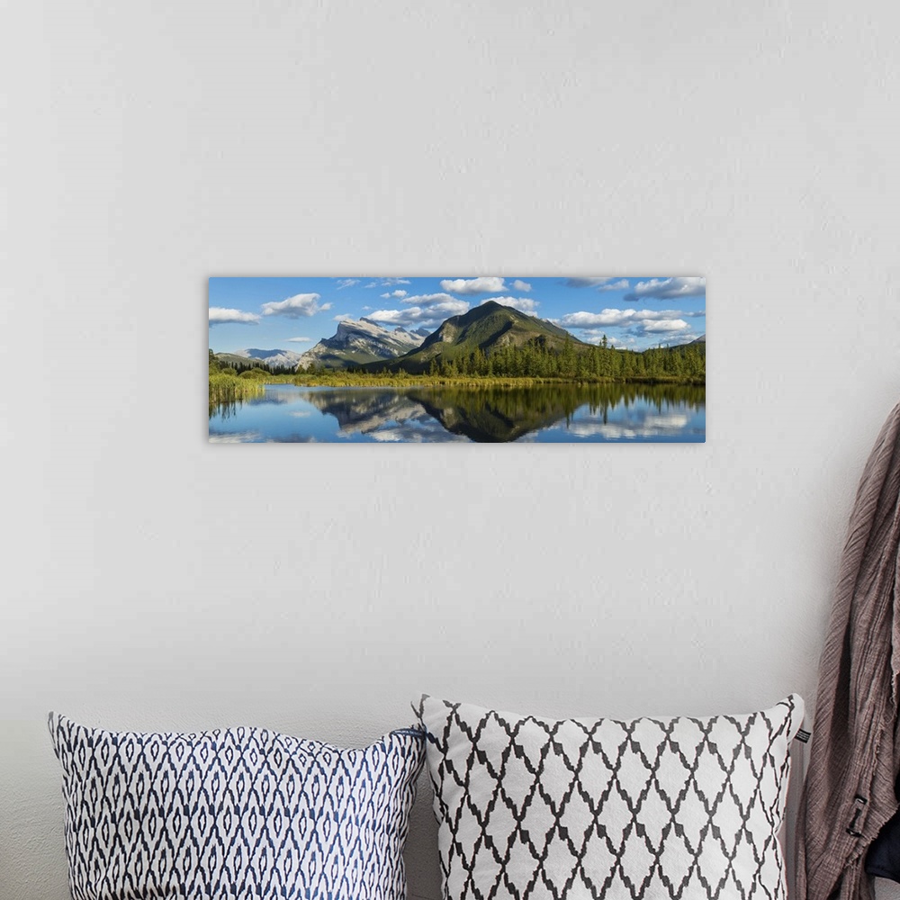 A bohemian room featuring Mount Rundle and Sulphur Mountain reflecting in Vermilion Lake, Canada