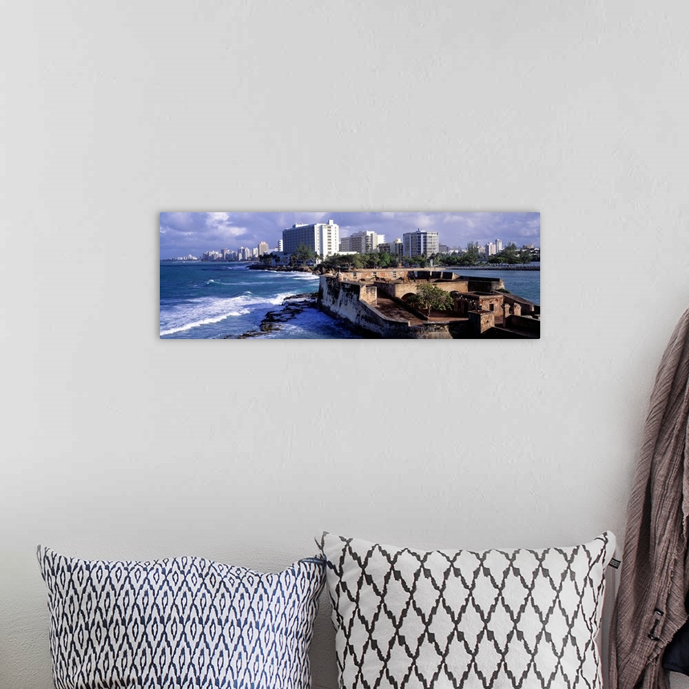 A bohemian room featuring Panoramic photograph of San Jeronimo Fort on the waters of San Juan, the city skyline in the back...