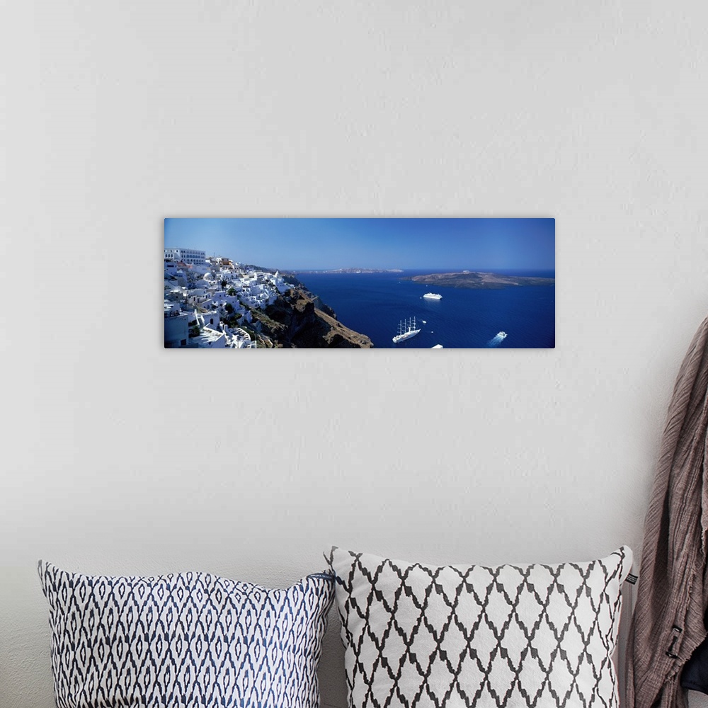 A bohemian room featuring Scenic photo of white houses sitting on the mountain Cliffside in Santorini, Greece with blue oce...