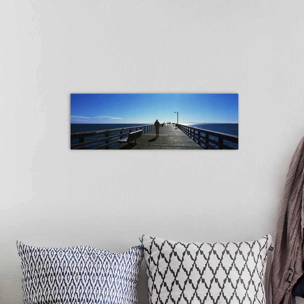 A bohemian room featuring Silhouette of a person walking on a pier, Goleta Beach Pier, Goleta, California, USA