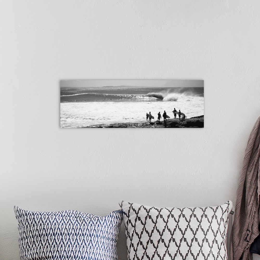 A bohemian room featuring Silhouette of surfers standing on the beach, Australia