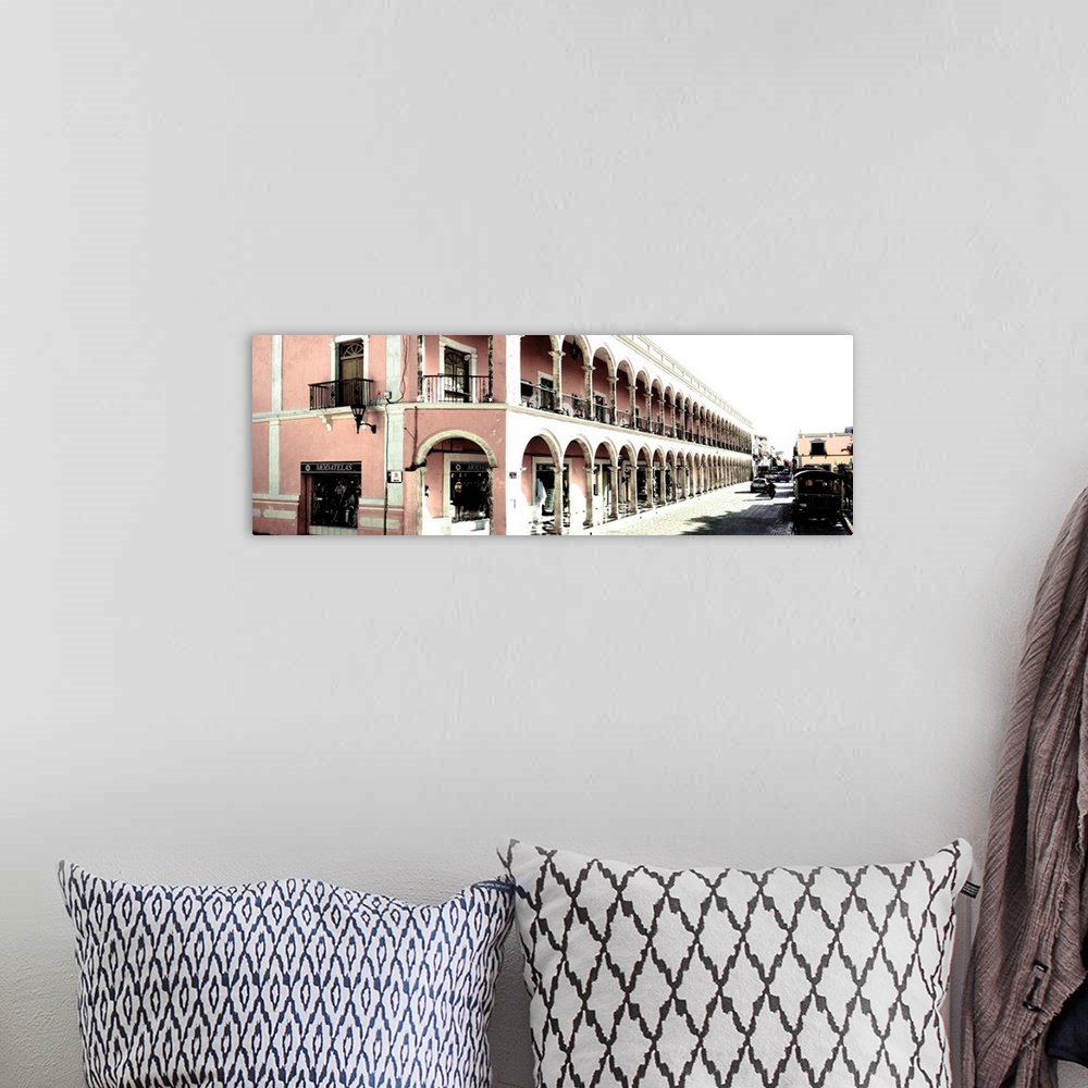 A bohemian room featuring Washed out panoramic photograph of a streetscape in Campeche, Mexico, with pink architecture. Fro...
