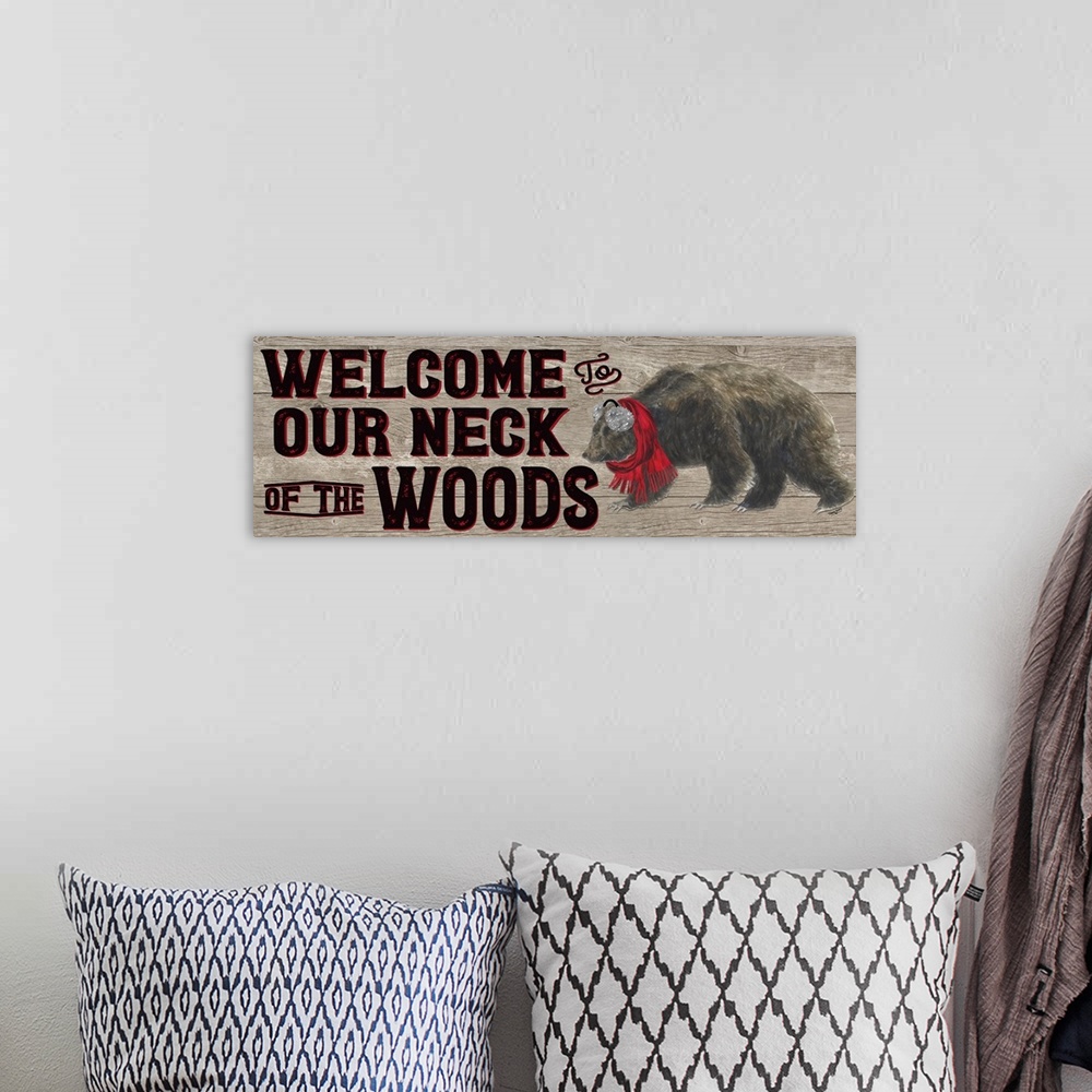 A bohemian room featuring Decorative image of 'Welcome To Our Neck Of The Woods' with a brown bear wearing ear muffs and a ...
