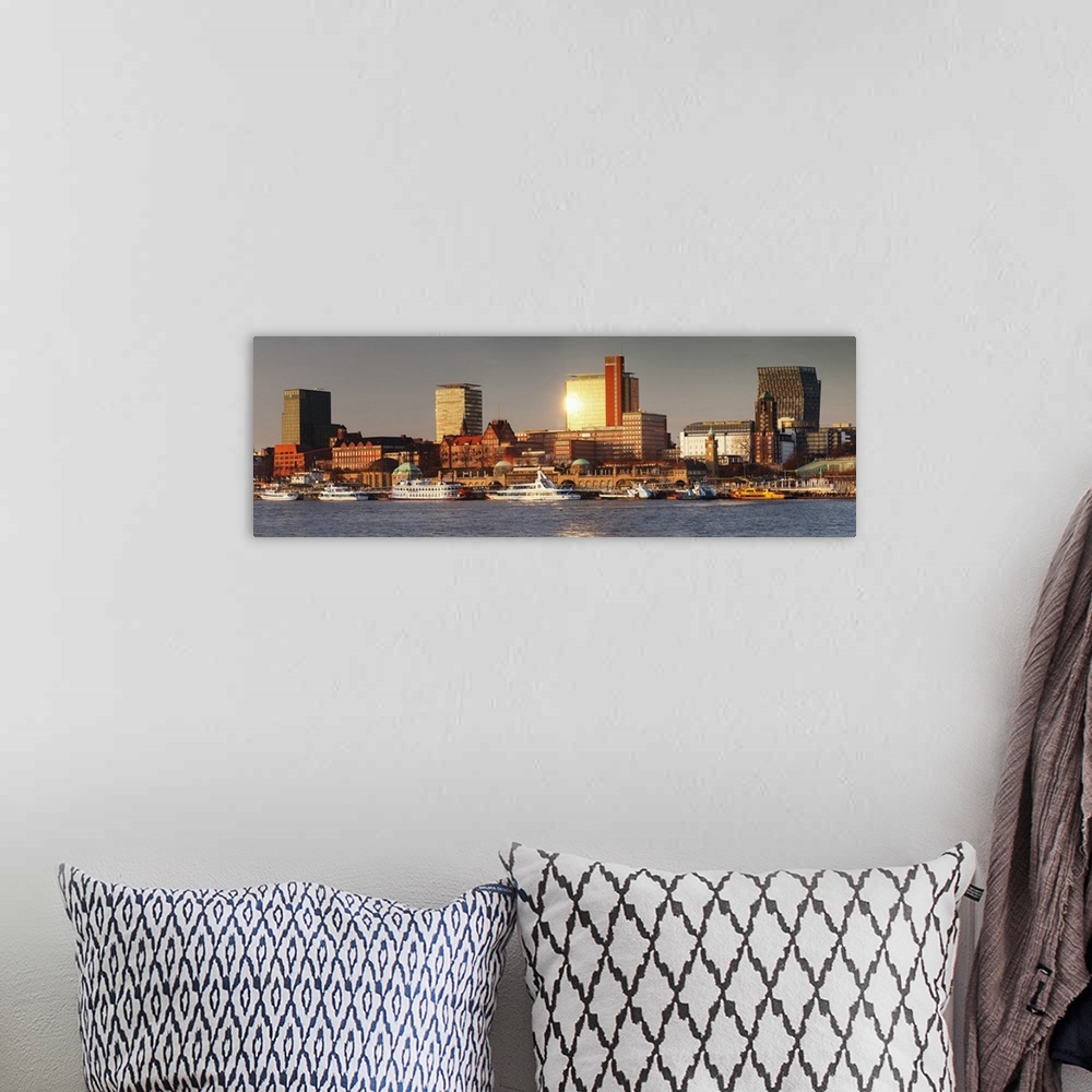 A bohemian room featuring View from Elbe River to St. Pauli Landungsbruecken pier and skyscraper Tanzende Tuerme at sunset,...