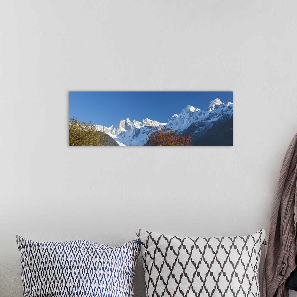 A bohemian room featuring Panorama of the snowy peaks framed by colorful trees, Soglio, Bregaglia Valley, Canton of Graubun...
