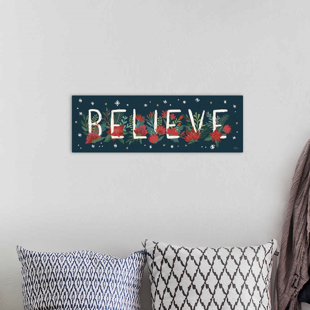 A bohemian room featuring Decorative artwork of red flowers and leaves with the text "Believe" on a dark navy background.