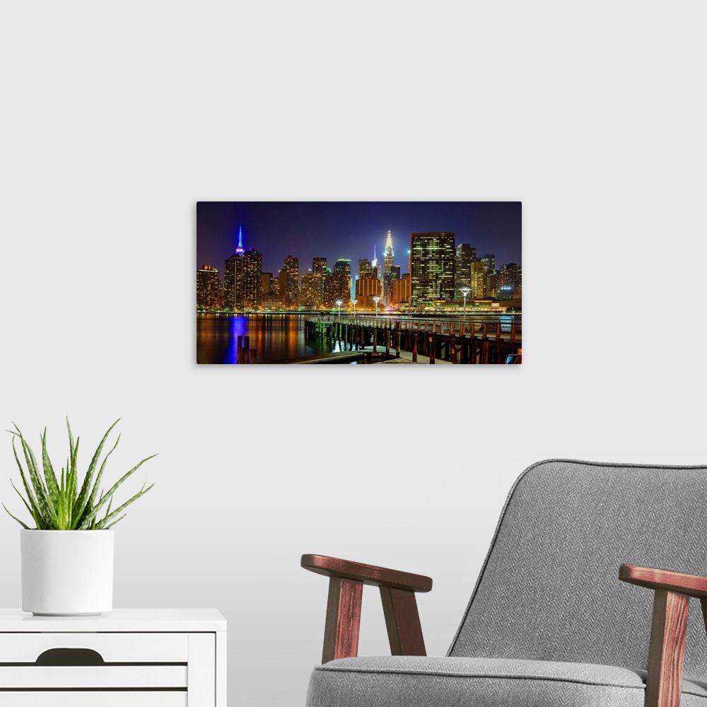 A modern room featuring Manhattan Panoramic View With UN From Long Island City At Night