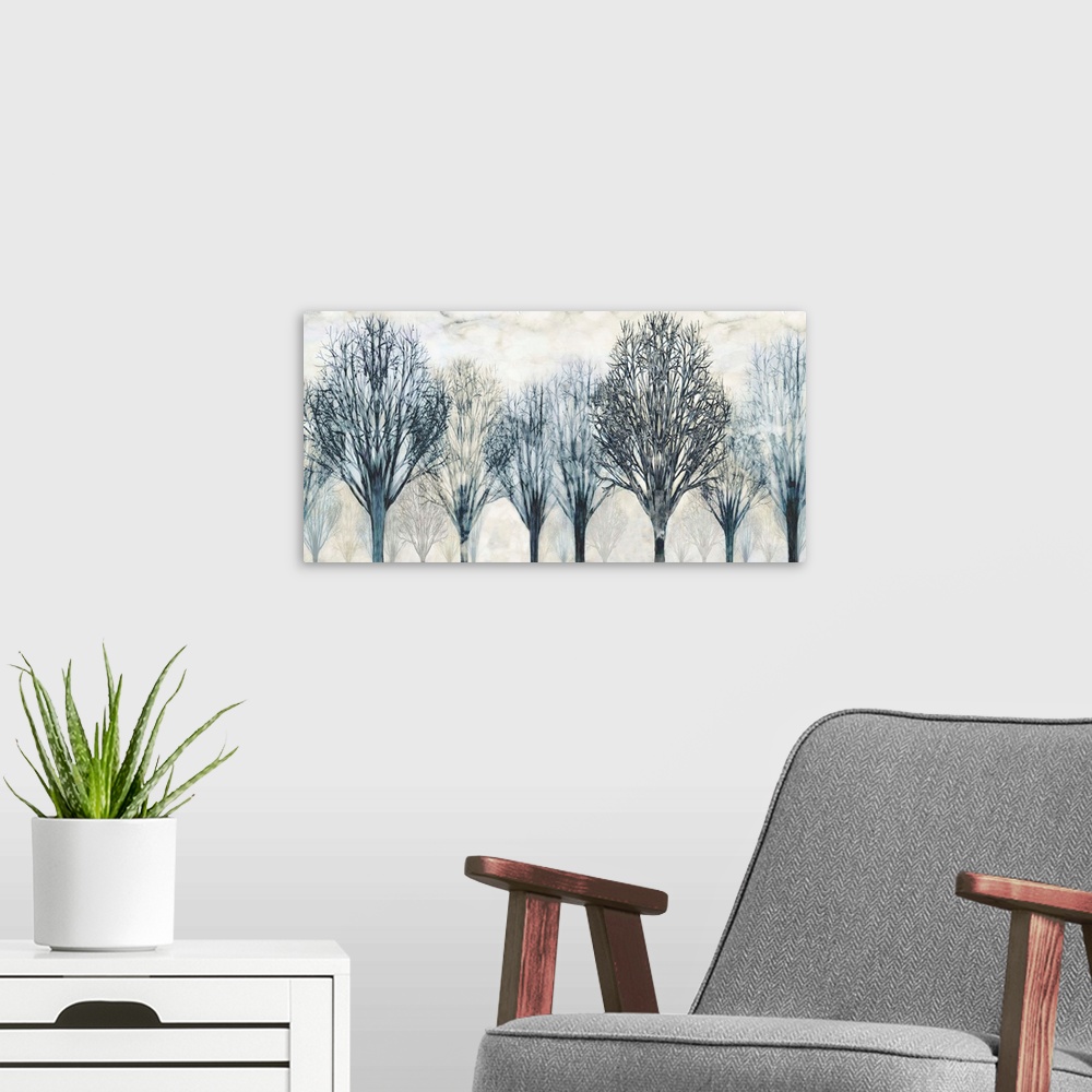 A modern room featuring Large artwork with Winter trees in dark blue and gray hues with a foggy background.