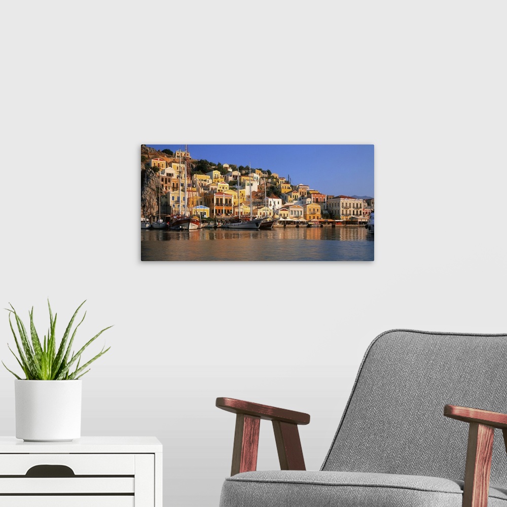 A modern room featuring Greece, Dodecanese, view towards the harbor and Neoclassical houses