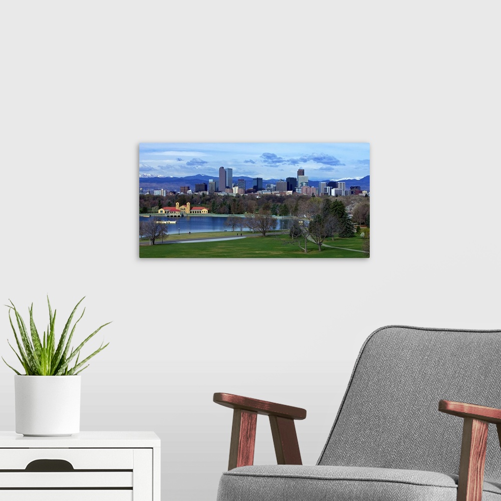 A modern room featuring Denver Skyline from City Park with boat house and lake and Mt. Evans in background.
