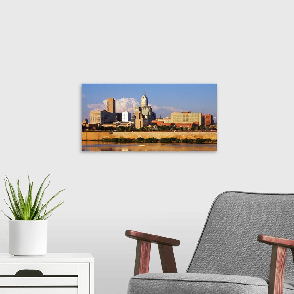 A modern room featuring Photograph of the Indianapolis, Indiana city skyline from the water on a sunny day.