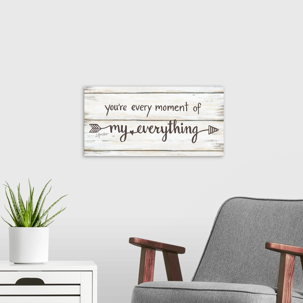 A modern room featuring This decorative artwork features the phrase: you're every moment of my everything, over a distres...