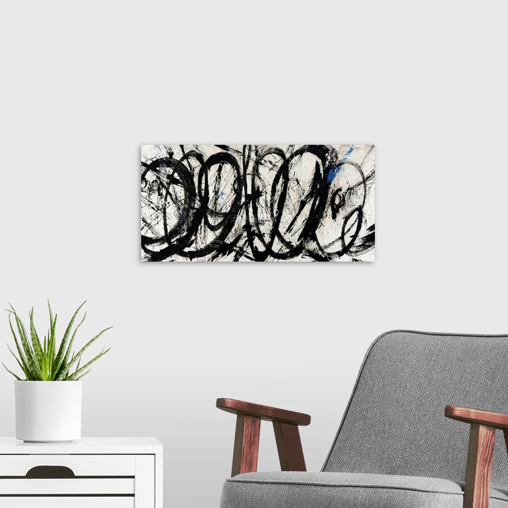A modern room featuring An abstract piece of artwork that has swirls of black paint throughout the panoramic print.