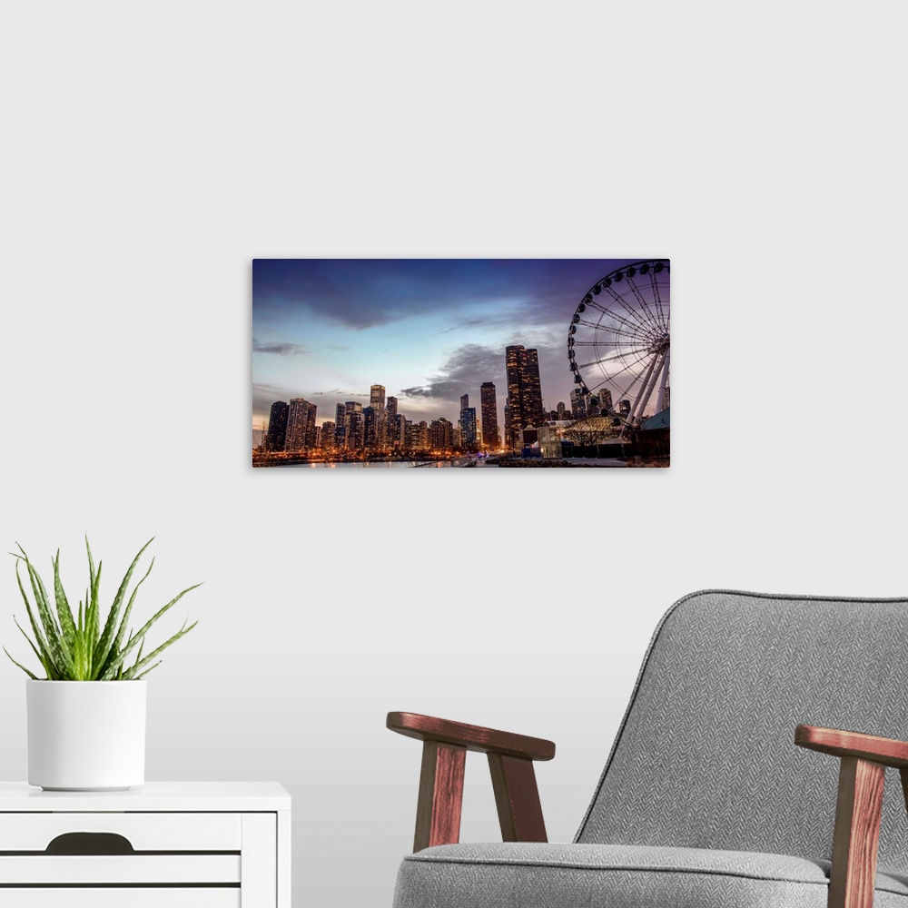 A modern room featuring View of the Chicago city skyline illuminated in the early evening with a Ferris Wheel in the fore...