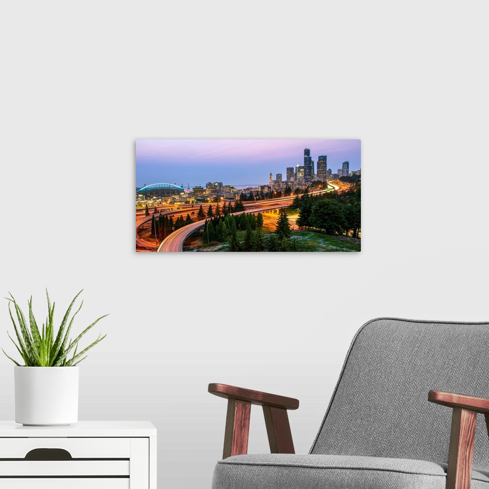 A modern room featuring Panoramic photograph of the Seattle skyline at night with light trails from the car lights on the...