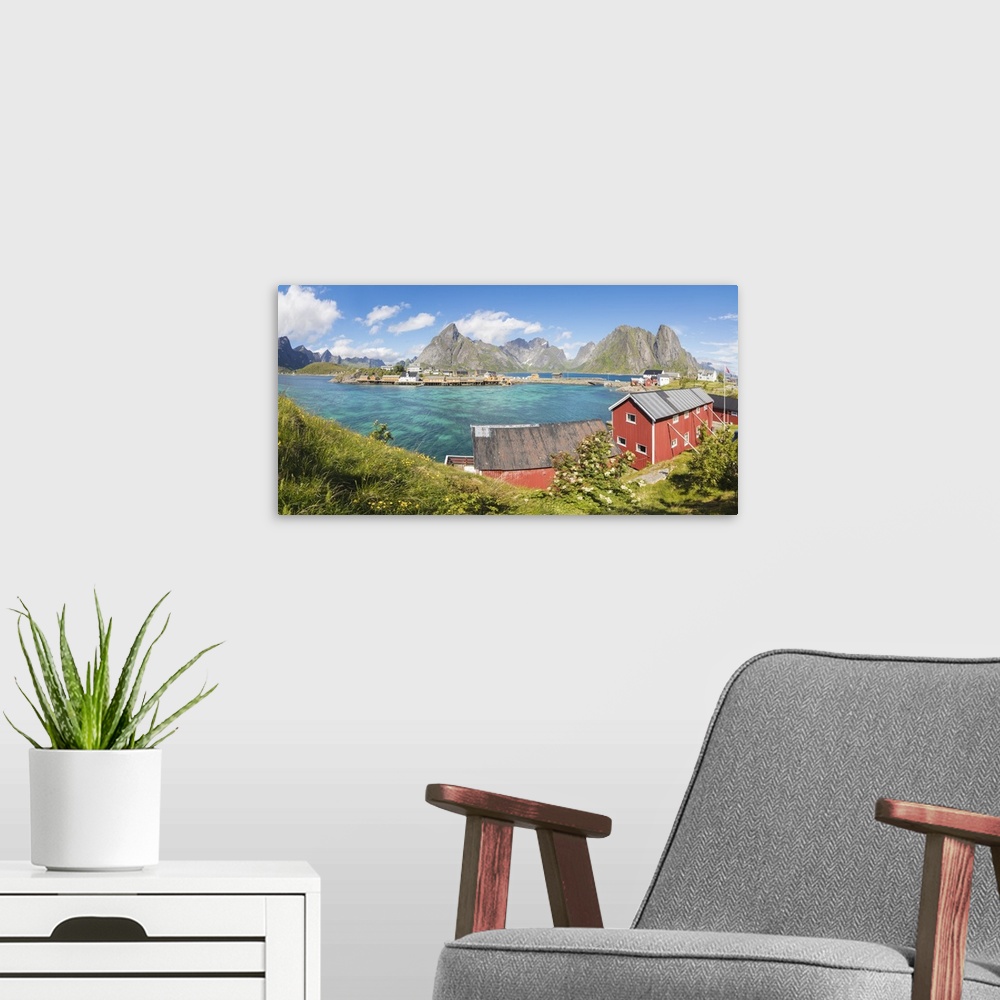 A modern room featuring Panorama of turquoise sea and typical fishing village surrounded by rocky peaks, Sakrisoy, Reine,...