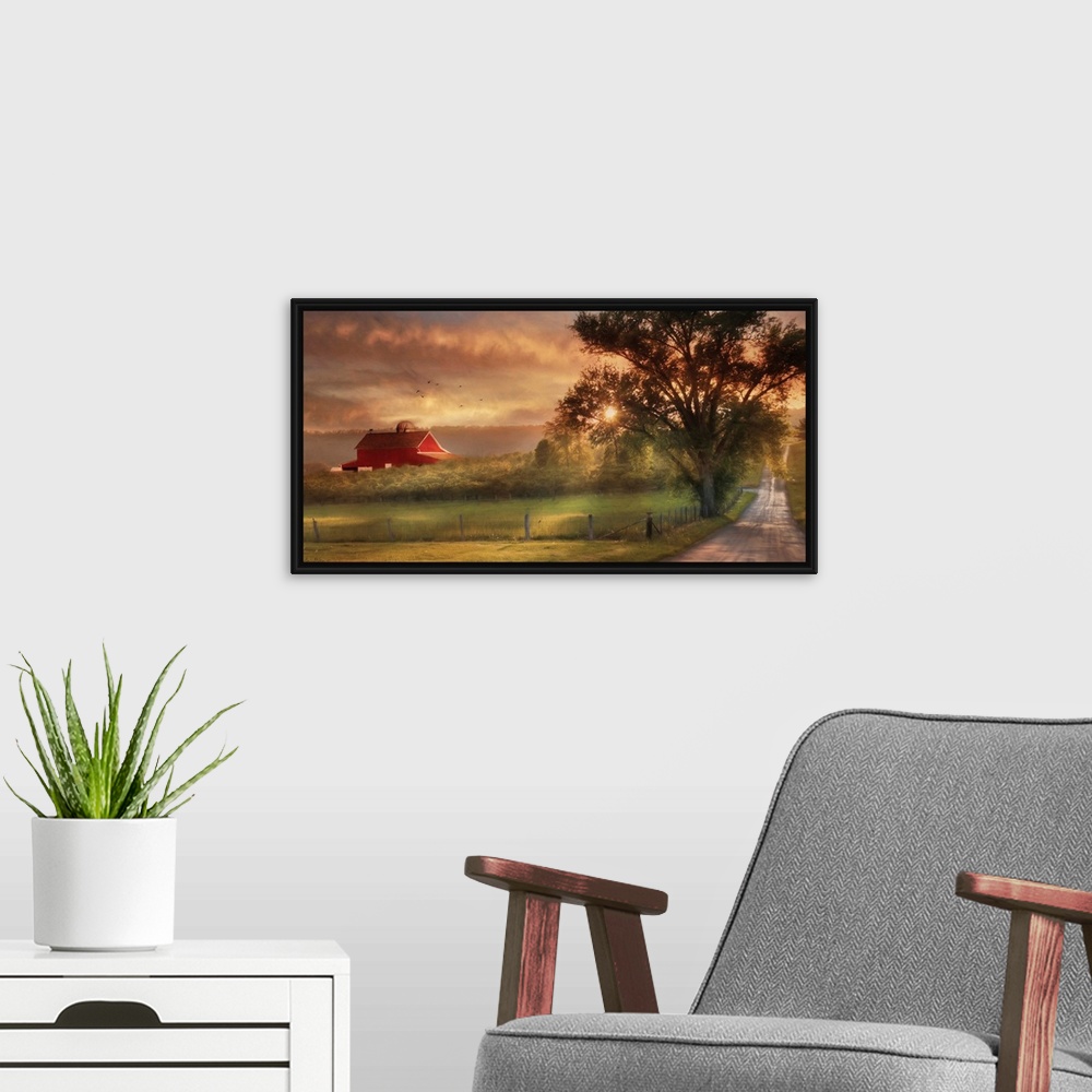 A modern room featuring A dirt road in the countryside with a red barn in the distance at sunset.