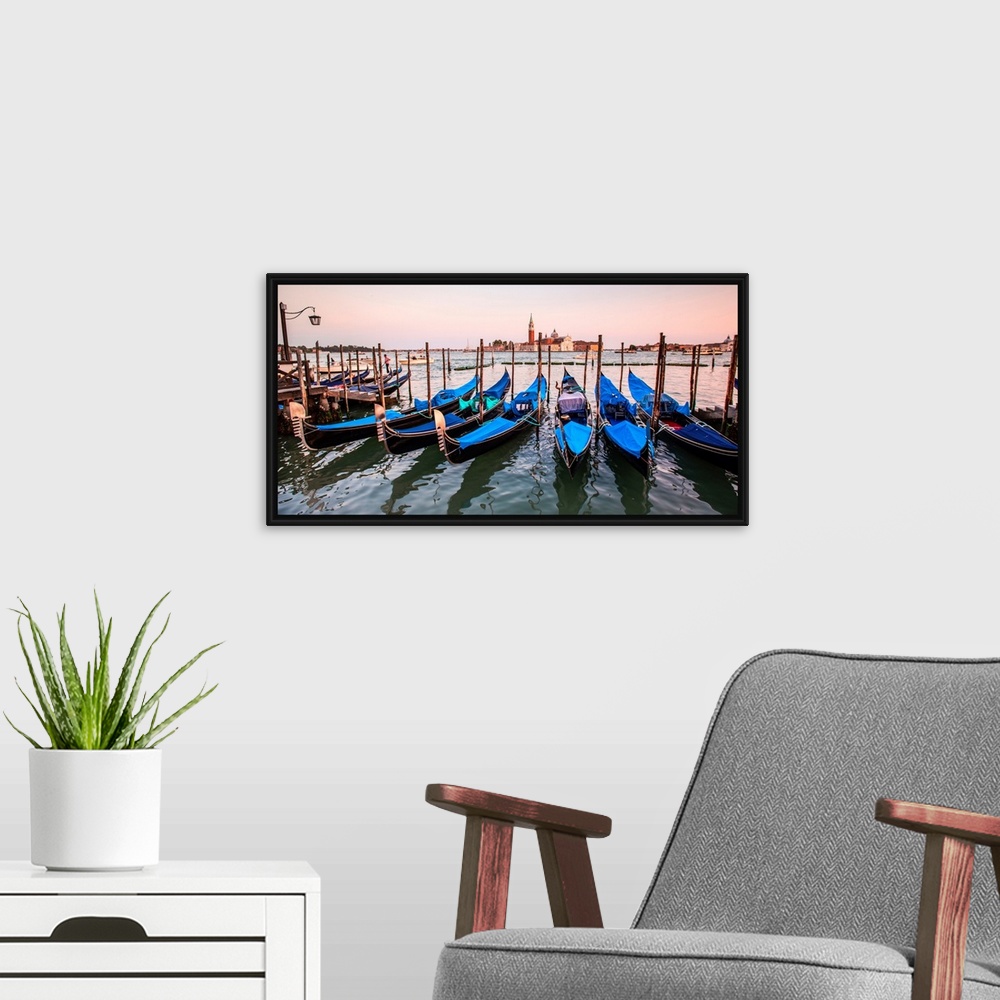 A modern room featuring Panoramic photograph of blue gondolas docked in a row on the water with St. Mark's Square in the ...