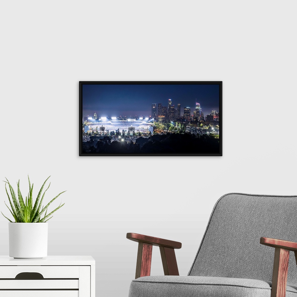 A modern room featuring Photograph of Dodger Stadium lit up on a game night with the Los Angeles skyline on the right.