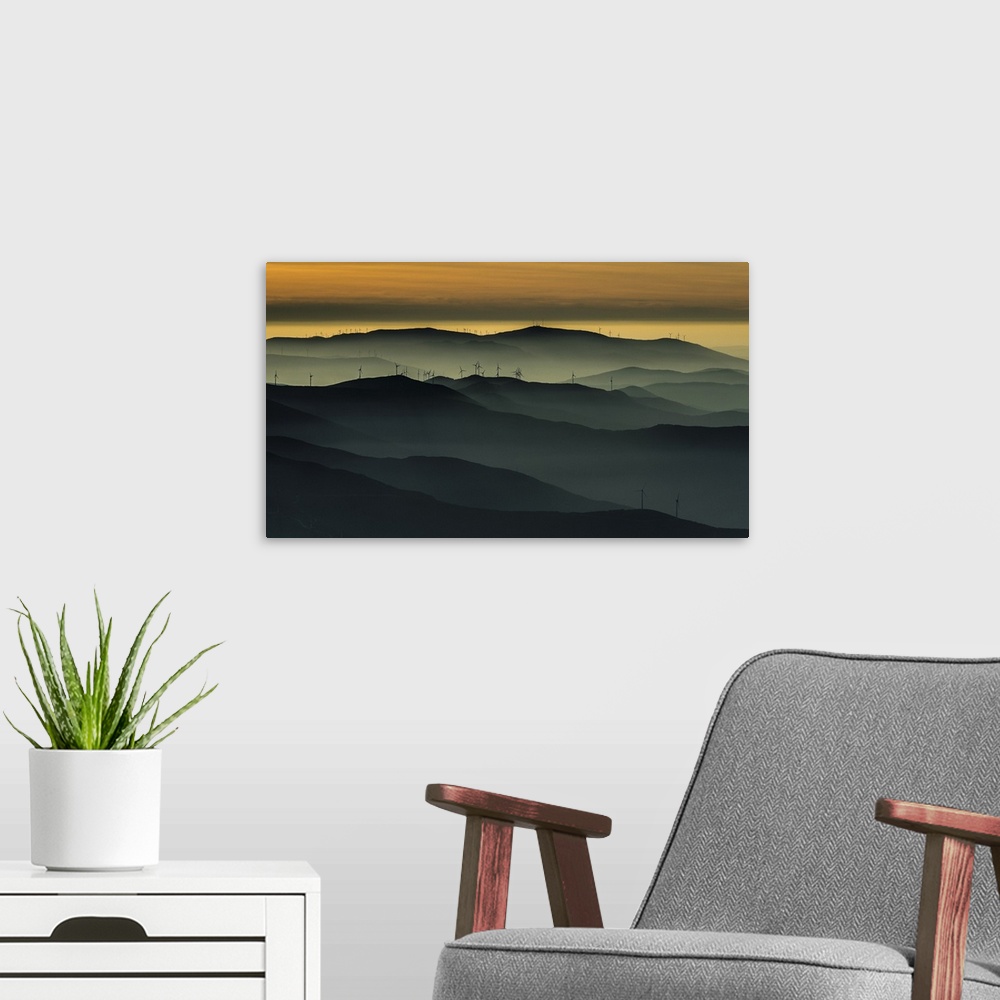 A modern room featuring Heavy fog settling over a wind farm in Portugal at sunset, in the Acor and Lousa mountains.