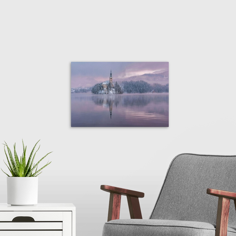 A modern room featuring Lake Bled with the church and the castle on a calm winter morning.