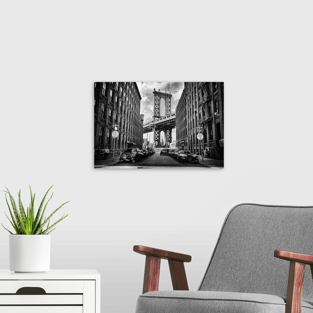 A modern room featuring A tower of the Manhattan Bridge framed by urban buildings in New York.