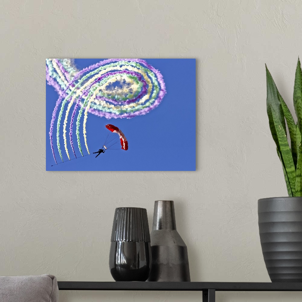 A modern room featuring A hanglider performing tricks and spirals in the air, leaving a trail of colorful smoke.