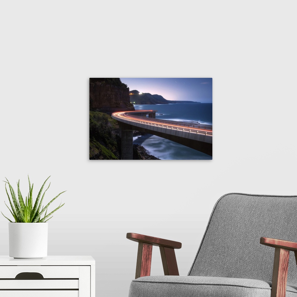 A modern room featuring Light trails from traffic on the Sea Cliff Bridge near Wollongong, Australia.