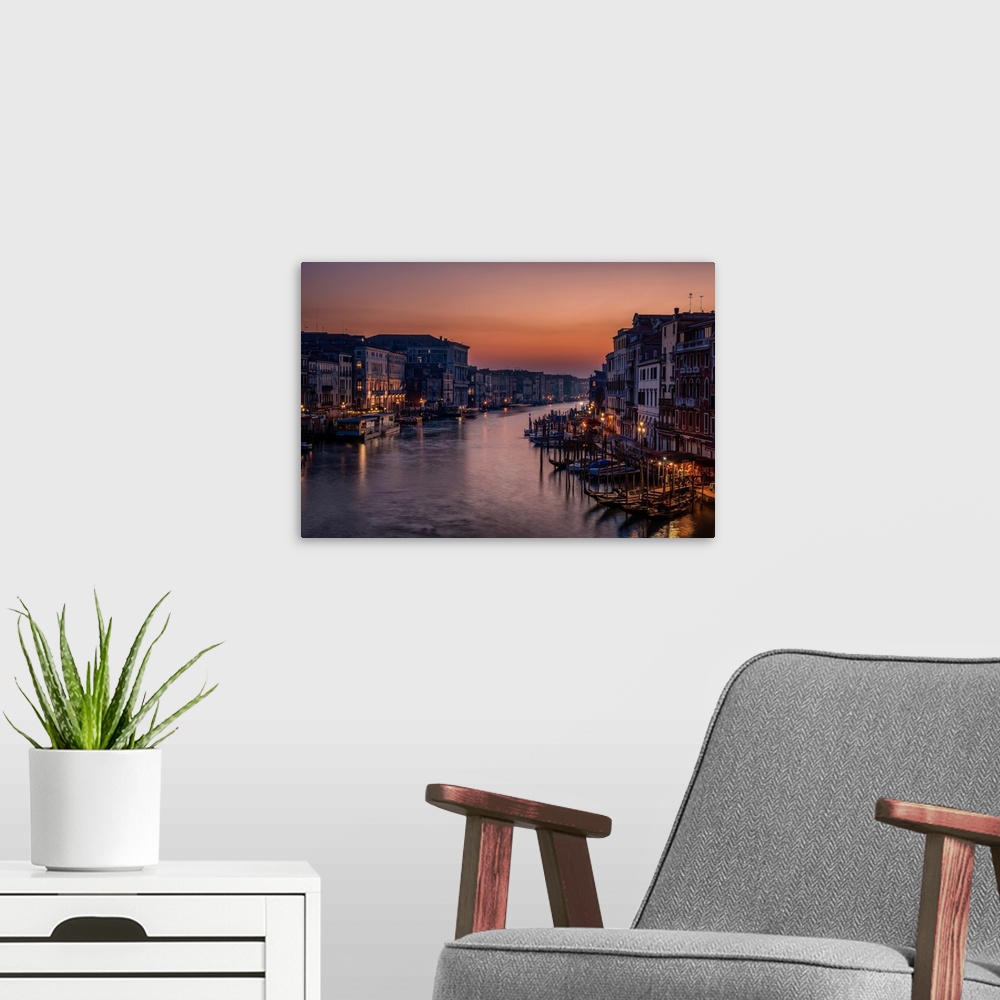 A modern room featuring Lights in the city of Venice surrounding the canal at twilight.