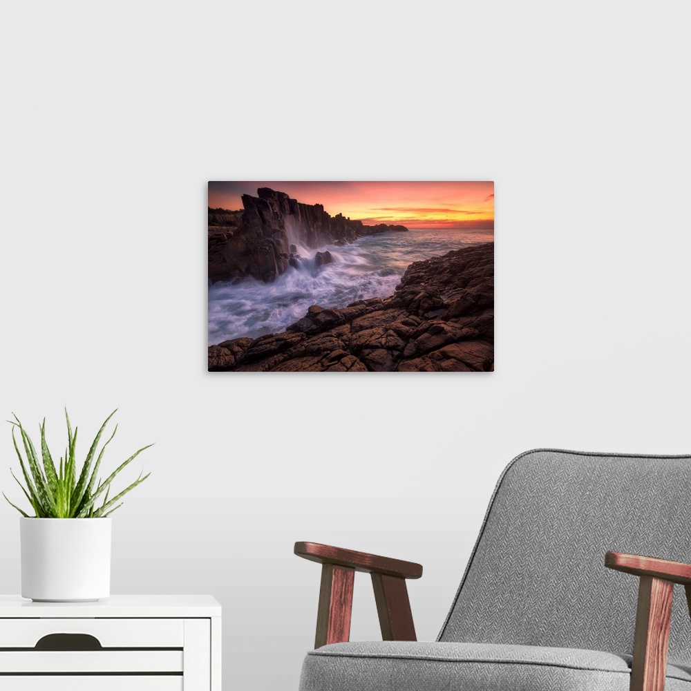 A modern room featuring Long exposure landscape photograph of rock formations with rushing water at sunrise, Kiama, Austr...