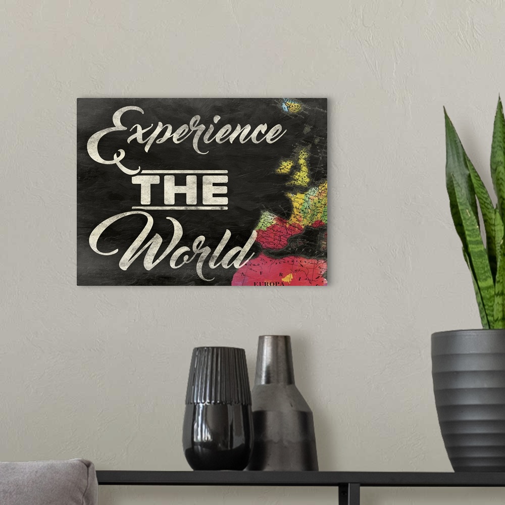 A modern room featuring "Experience the World" painted on a chalkboard background with a colorful map on the right side.