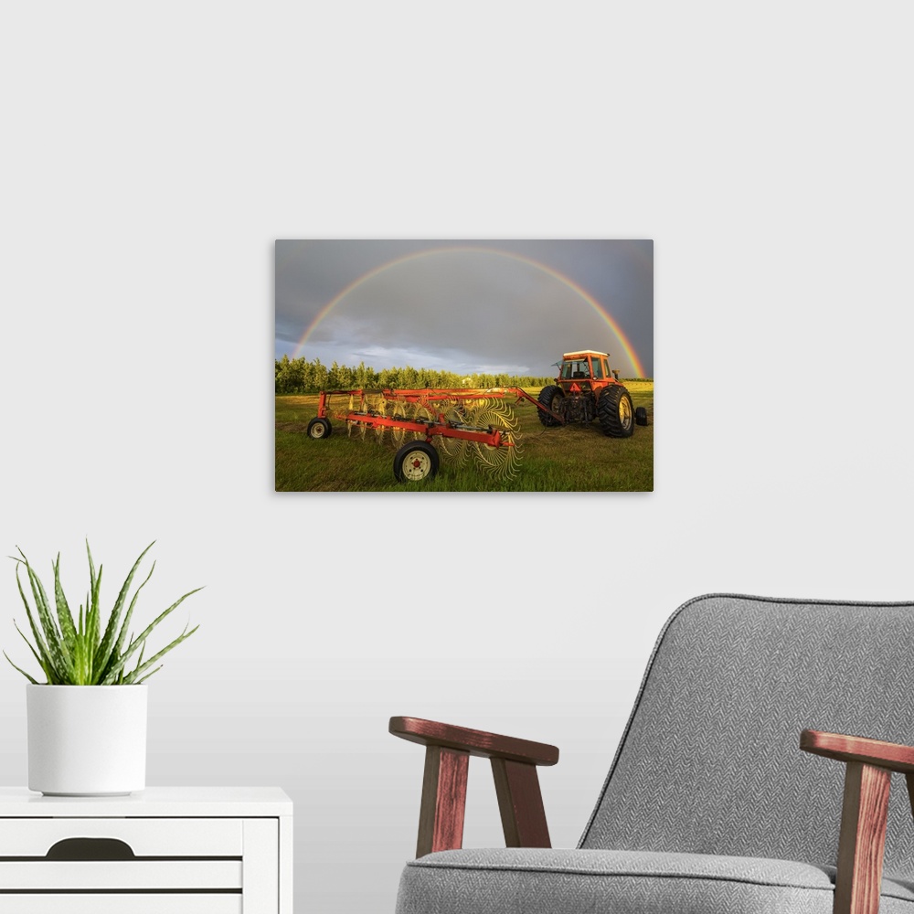 A modern room featuring A rainbow appears in the sky over a tractor which has just raked a field of hay; Delta Junction, ...