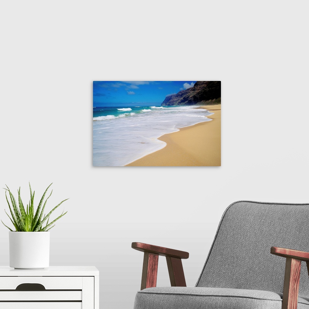 A modern room featuring Horizontal, oversized photograph of the shoreline at Polihale Beach in Kauai, Hawaii.  A cliff an...