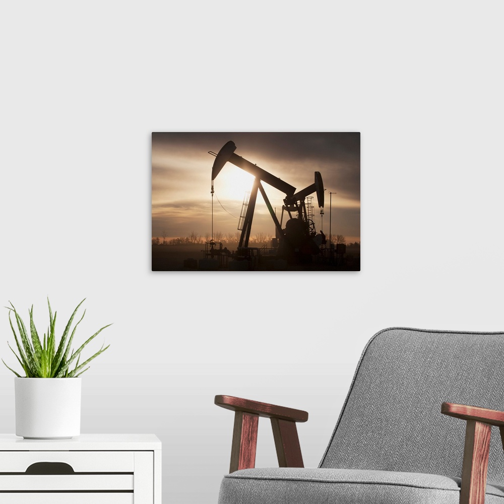 A modern room featuring Silhouette Of Two Pump Jacks At Sunrise With Clouds; Alberta, Canada